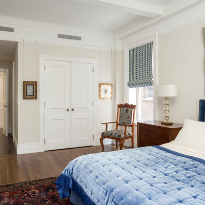 Bedroom - traditional medium tone wood floor and brown floor bedroom idea in New York with beige walls