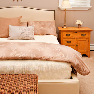 Elegant carpeted bedroom photo in Other with beige walls
