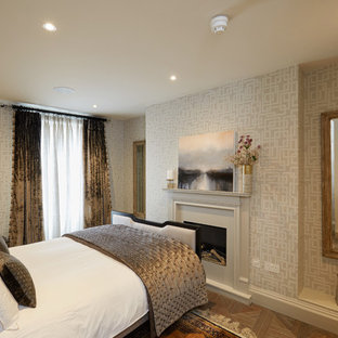 Design ideas for a medium sized classic guest bedroom in Sussex with grey walls, marble flooring, white floors, a standard fireplace and a plastered fireplace surround.