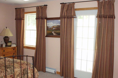 Example of a transitional bedroom design in Burlington