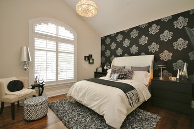 Inspiration for a mid-sized transitional guest medium tone wood floor bedroom remodel in Ottawa with beige walls