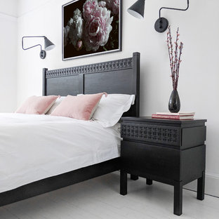 This is an example of a classic bedroom in Sussex with painted wood flooring and white floors.