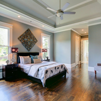 Inspiration for a mid-sized transitional master medium tone wood floor bedroom remodel in Atlanta with gray walls and no fireplace