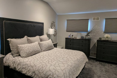 Inspiration for a mid-sized transitional master carpeted and gray floor bedroom remodel in New York with gray walls