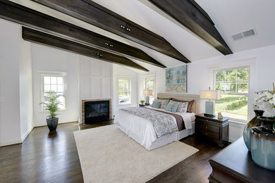 Inspiration for a mid-sized transitional master medium tone wood floor bedroom remodel in DC Metro with white walls, a standard fireplace and a stone fireplace