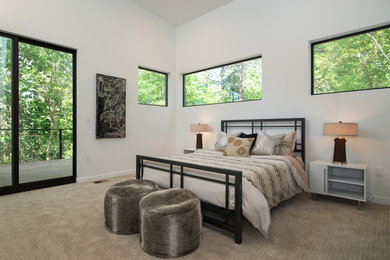 This is an example of a large modern master bedroom in Seattle with white walls, carpet and no fireplace.