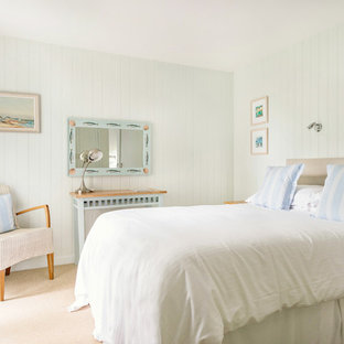 Photo of a small coastal bedroom in Cornwall with green walls, carpet and beige floors.