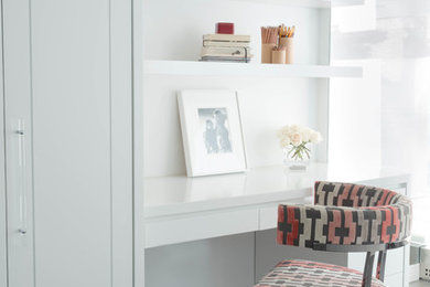 This is an example of a contemporary grey and pink bedroom in New York with white walls, dark hardwood flooring and grey floors.