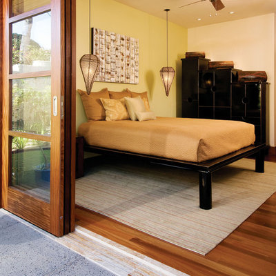 Example of an island style medium tone wood floor bedroom design in Hawaii