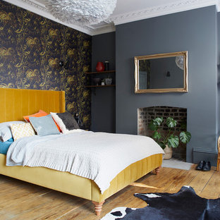 This is an example of a medium sized bohemian guest bedroom in London with grey walls, medium hardwood flooring and brown floors.