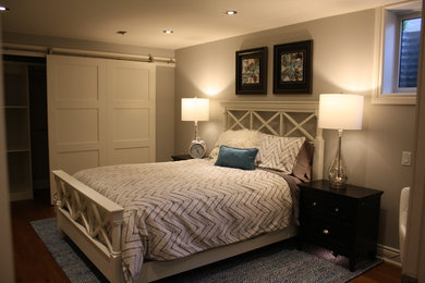 Ejemplo de dormitorio tradicional renovado de tamaño medio con paredes grises, suelo de madera en tonos medios y suelo marrón