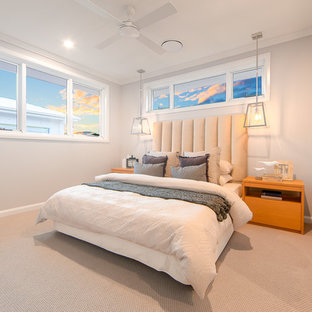 Beach style guest bedroom in Gold Coast - Tweed with beige walls, carpet and beige floor.