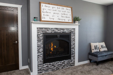 Master carpeted bedroom photo in Other with gray walls, a two-sided fireplace and a tile fireplace