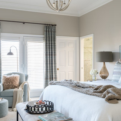 Example of a large transitional master carpeted and beige floor bedroom design in Dallas with beige walls, a corner fireplace and a stone fireplace