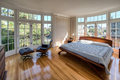 Design ideas for a large classic master bedroom in San Francisco with beige walls and light hardwood flooring.