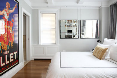 Mid-sized transitional master medium tone wood floor bedroom photo in New York with gray walls and no fireplace