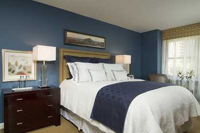 Example of a small transitional master carpeted bedroom design in New York with blue walls