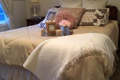 This is an example of a small traditional guest bedroom in Calgary with beige walls, carpet, no fireplace and beige floors.