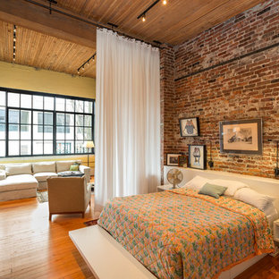 Example of a large urban medium tone wood floor bedroom design in Seattle with no fireplace
