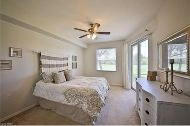 Small transitional master carpeted bedroom photo in Miami with gray walls and no fireplace