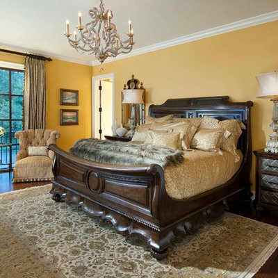 Inspiration for a large mediterranean master dark wood floor bedroom remodel in Other with yellow walls