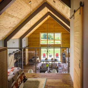 Bedroom - mid-sized rustic master medium tone wood floor and brown floor bedroom idea in Burlington with brown walls and no fireplace