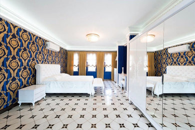 Design ideas for an expansive mediterranean guest bedroom in London with blue walls, ceramic flooring and white floors.