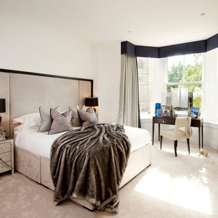 Contemporary bedroom in Manchester with white walls, carpet and beige floors.