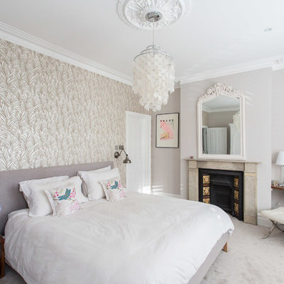 Bedroom - mid-sized contemporary master carpeted bedroom idea in London with gray walls, a standard fireplace and a stone fireplace
