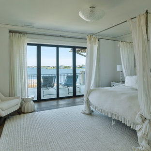 Imagen de dormitorio principal, mediterráneo, con paredes blancas, suelo de madera oscura y suelo marrón
