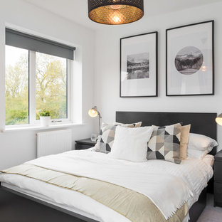 Medium sized scandinavian bedroom in Buckinghamshire with white walls, carpet, no fireplace and grey floors.