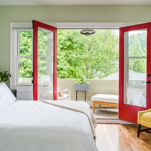Example of a transitional master light wood floor bedroom design in Atlanta with green walls and no fireplace