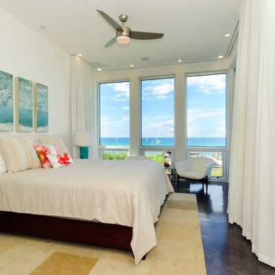 Island style master bedroom photo in Miami with white walls