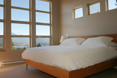 Contemporary master bedroom in Calgary with carpet.