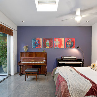Eclectic guest bedroom in Sydney with purple walls, grey floor and porcelain floors.