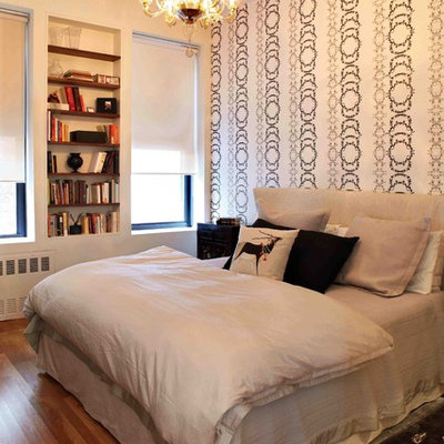 Example of a trendy medium tone wood floor bedroom design in New York with beige walls