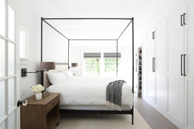 Transitional master dark wood floor and brown floor bedroom photo in Vancouver with white walls