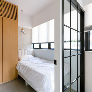 Aménagement d'une petit chambre parentale asiatique avec un mur blanc, béton au sol, aucune cheminée et un sol gris.