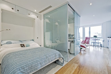 Example of a mid-sized trendy light wood floor bedroom design in Toronto with white walls