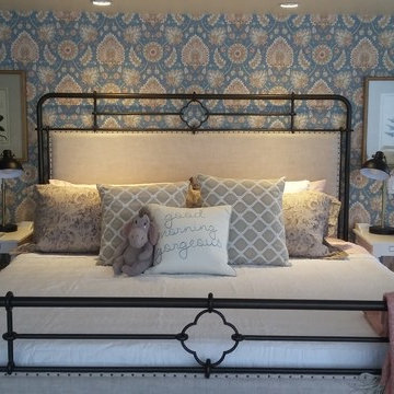 Wallpapered head board wall adds to the vintage feel of the space