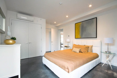 Mid-sized trendy master concrete floor and gray floor bedroom photo in New York with white walls and no fireplace