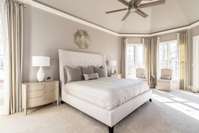 Photo of a large traditional master bedroom in Charlotte with grey walls, carpet, a two-sided fireplace, a tiled fireplace surround and a drop ceiling.
