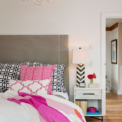 Inspiration for a timeless medium tone wood floor bedroom remodel in Providence with white walls
