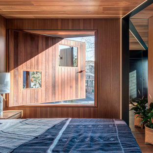 Inspiration for an industrial bedroom in Sydney with wood and wood walls.