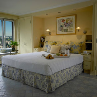 Inspiration for a large transitional master bedroom in New York with yellow walls and ceramic floors.