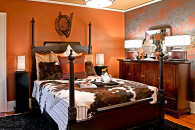 Bedroom - mid-sized eclectic master light wood floor bedroom idea in Cleveland with orange walls