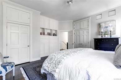 Inspiration for a mid-sized timeless dark wood floor and brown floor bedroom remodel in Richmond with white walls