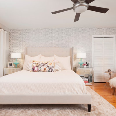 Transitional master medium tone wood floor bedroom photo in Austin with gray walls