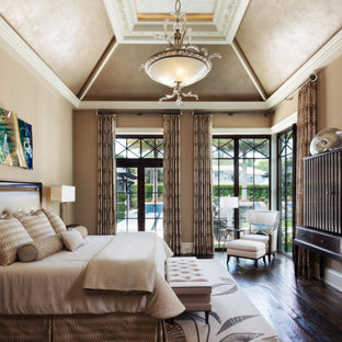 Example of a classic master medium tone wood floor, brown floor, vaulted ceiling and shiplap wall bedroom design in Miami with beige walls and no fireplace