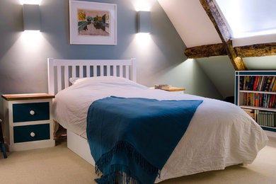 Design ideas for a medium sized classic guest bedroom in Oxfordshire with blue walls, carpet and beige floors.